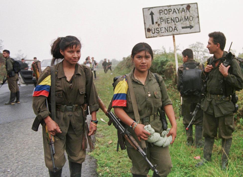 FARC rebels stand guard during a roadblock after they attacked Silvia town in Cauca province, May 1999.
