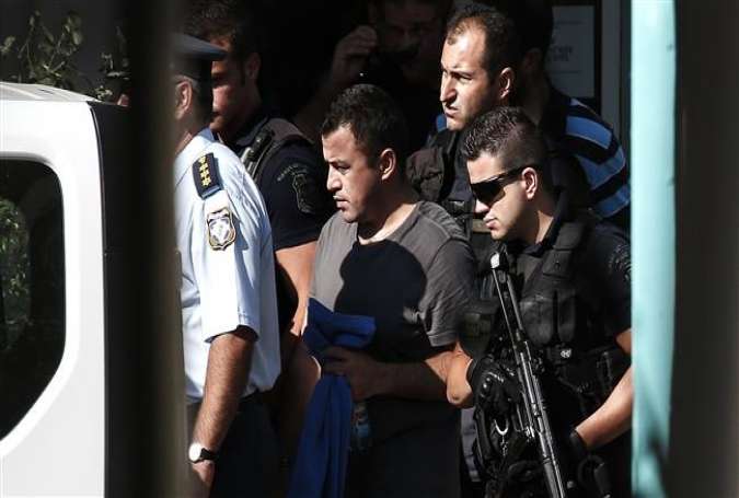 In this July 27, 2016 file photo, a Turkish military officer, center, is escorted by policemen as he leaves a building of the Greek Asylum Service in Athens.