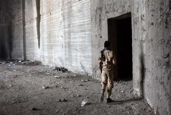 A member of the Syrian government forces inspects a building in west Aleppo