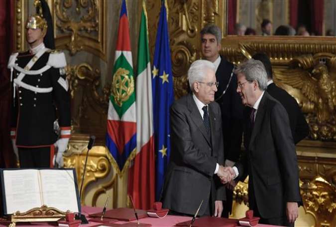 Newly-appointed Prime Minister Paolo Gentiloni (R) shakes hands with Italian President Sergio Mattarella during the swearing in ceremony of the new government on December 12, 2016 at the Quirinale presidential Palace in Rome.