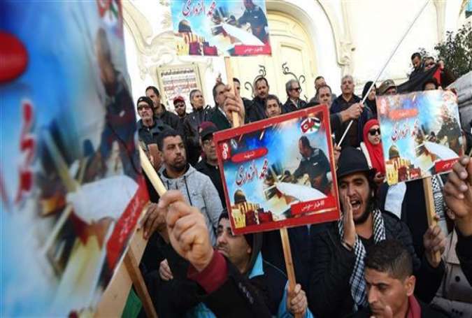 Tunisians take part in a demonstration against Israel’s killing of a drone expert in the capital, Tunis, December 20, 2016.
