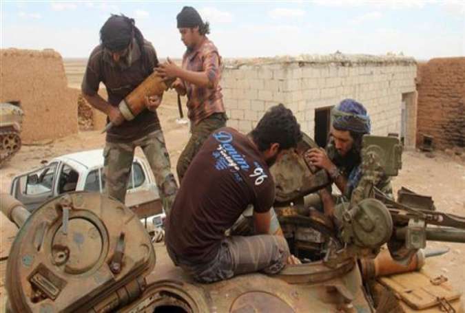 File photo shows militants from Jaish al-Fatah (or Army of Conquest) loading ammunition into a tank during clashes with Syrian government forces near the village of Om al-Krameel, in Aleppo