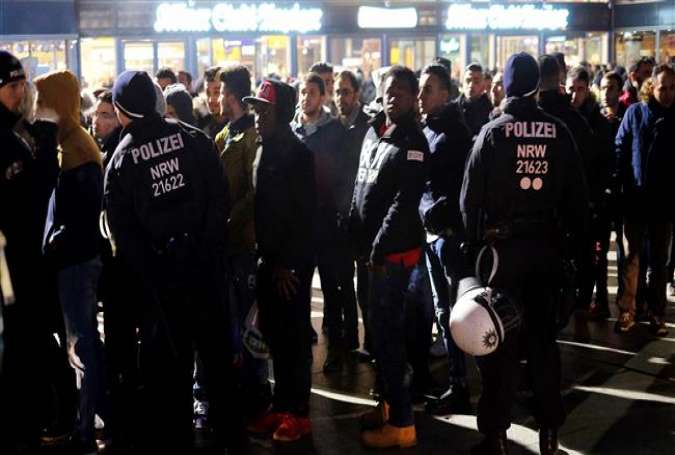 German police monitor people during New Year celebrations at the main train station in Cologne.