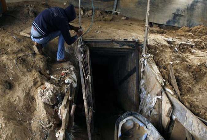 In this file photo, a Palestinian man works outside a lifeline tunnel, which connects the Gaza Strip and Egypt.