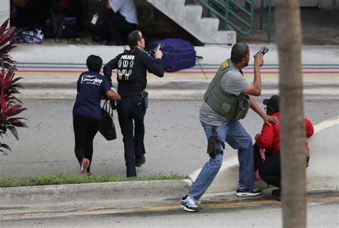 Police assist people seeking cover outside Terminal 2 of Fort Lauderdale-Hollywood International airport after a shooting took place near the baggage claim on January 6, 2017 in Fort Lauderdale, Florida.