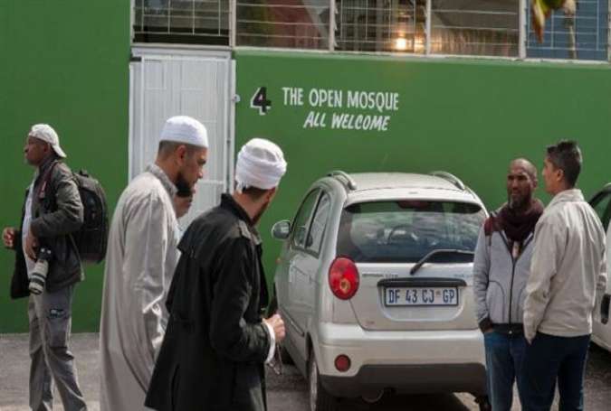 Muslim worshipers stand by at Cape Town mosque amid reports that two mosque in the city were defaced in rare Islamophobic acts in the country.