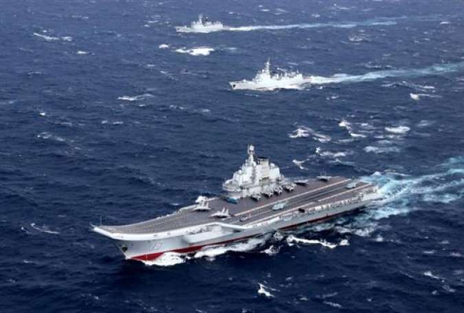 China’s Liaoning aircraft carrier, with an accompanying fleet, conducts a military exercise in the South China Sea.
