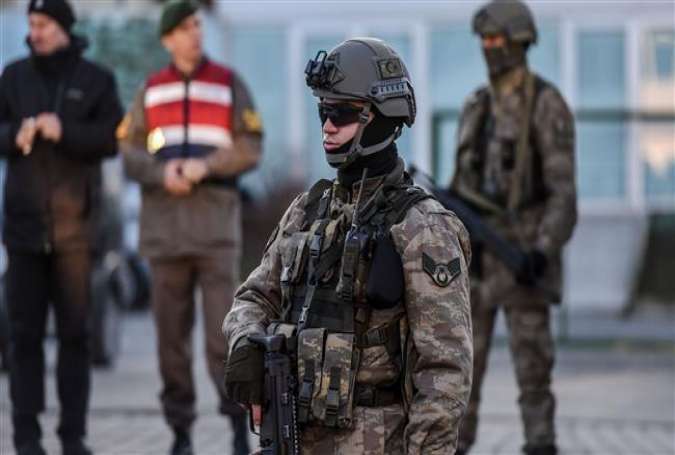 A Turkish soldier stands guard next to the courthouse as a vehicle transporting prisoners passes at Silivri District in Istanbul, December 27, 2016.