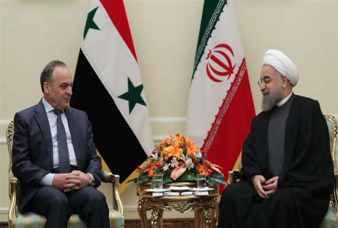 Iran’s President Hassan Rouhani (R) meets with Syrian Prime Minister Imad Khamis in Tehran, January 18, 2017.