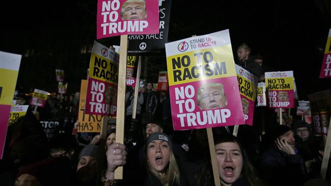 Demonstrators hold placards as they protest outside the US Embassy in London, Britain, on January 20, 2017, to coincide with the inauguration of Donald Trump as the 45th president of the United States.