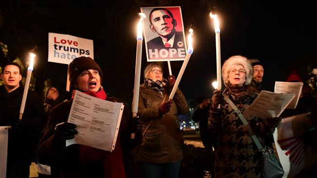 People rally during an anti-Trump protest on the day of his inauguration as US president in front of the US Embassy building in Budapest, Hungary, on January 20, 2017.