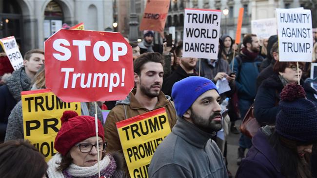 Demonstrators hold placards in Madrid, Spain, on January 20, 2017 during a protest against Trump as his presidential inauguration kicks off in Washington, DC.
