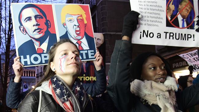 Demonstrators hold placards in Madrid, Spain, on January 20, 2017 during a protest against Trump as his presidential inauguration kicks off in Washington, DC.