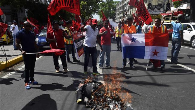 Panamanians protest Trump's inauguration, burning an effigy of him, in Panama City on January 20, 2017.