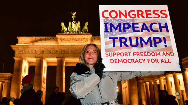 A German protester shows a banner during an anti-Trump rally on the day of his inauguration as US president, in front of Brandenburg Gate in Berlin, Germany, on January 20, 2016.