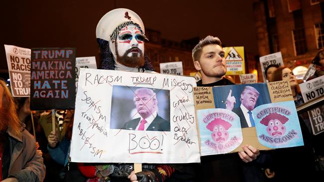Demonstrators hold up banners during a protest against the inauguration of Trump as US president in Edinburgh, Scotland, on January 20, 2017.