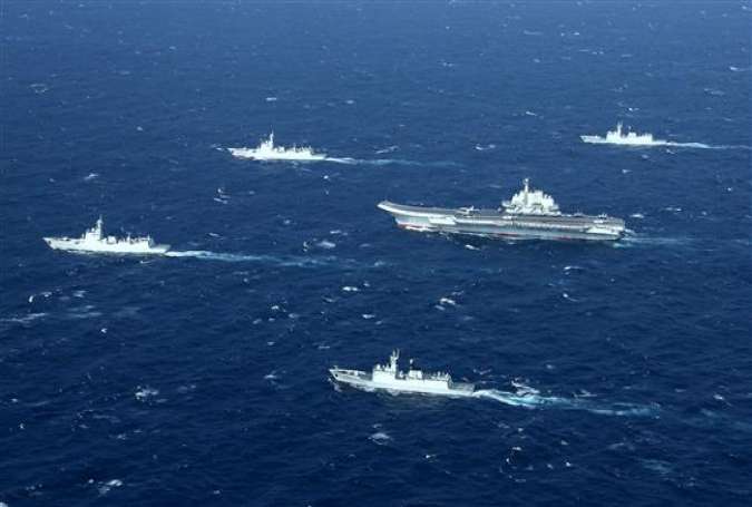 This aerial photo, taken on January 2, 2017, shows a Chinese navy formation, including the aircraft carrier Liaoning (C), during military drills in the South China Sea.