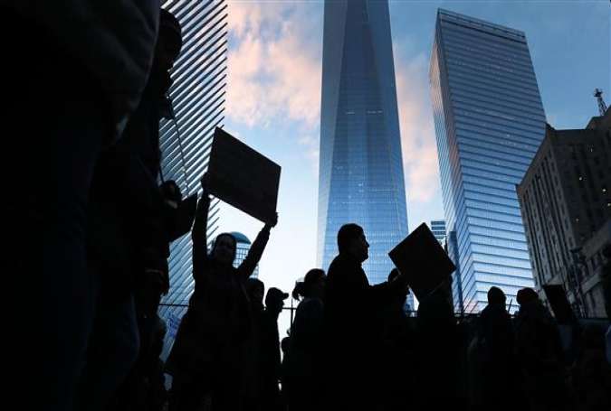 Thousands pass One World Trade during an afternoon rally in lower Manhattan to protest President Donald Trump