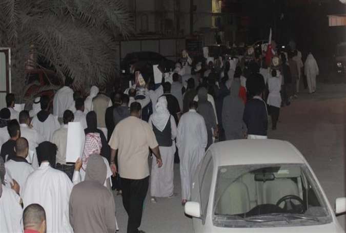 This photo shows Bahraini people taking part in a protest in support of top Shia cleric Sheikh Isa Qassim in the village of Ma