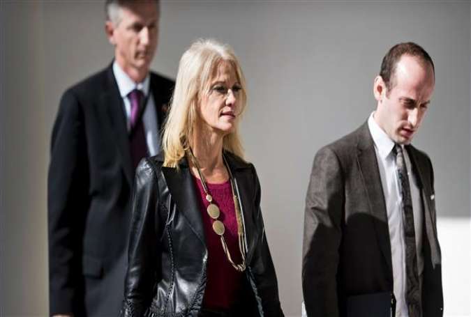 Counselor to US President Trump, Kellyanne Conway (center) and adviser Stephen Miller (right) walk through the colonnade of the White House on February 10, 2017 in Washington, DC.