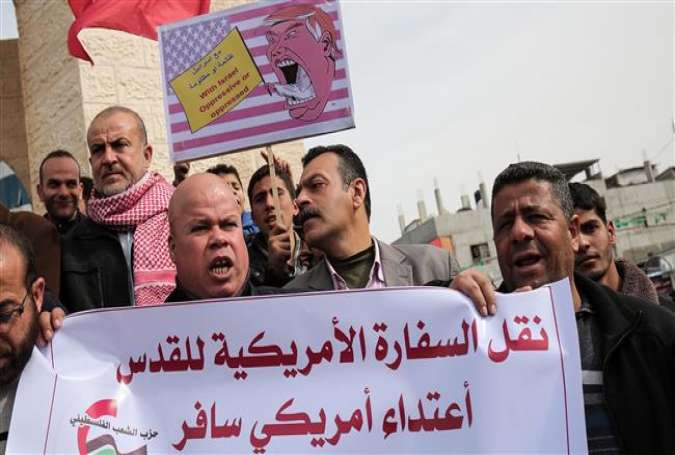 Palestinian protesters hold placards during a demonstration against US President Donald Trump’s pledge to move the American embassy from Tel Aviv to Jerusalem al-Quds, in Rafah, southern Gaza Strip, January 24, 2017.