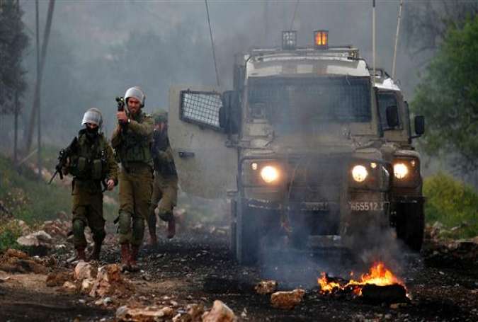 Israeli forces hold position during clashes with Palestinian protesters following a weekly demonstration against the expropriation of Palestinian land by Israel in the village of Kfar Qaddum, near Nablus, in the occupied West Bank on March 3, 2017.