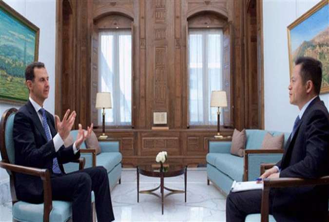 Syrian President Bashar Assad (L) speaks in an interview with China’s PHOENIX TV.