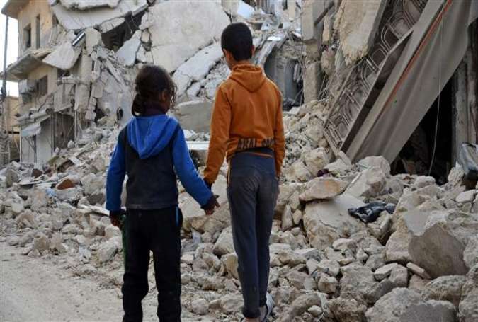Two Syrian children stand by in front of the rubble of a destroyed house in the northern Syrian town of al-Bab, after Turkish-backed forces announced its recapture from Daesh on March 7, 2017.