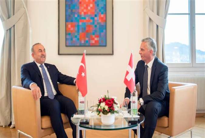 Turkish Foreign Minister Mevlut Cavusoglu (L) meets with Swiss Federal Councillor Didier Burkhalter in Bern, Switzerland, March 23, 2017. (Photo by AFP)