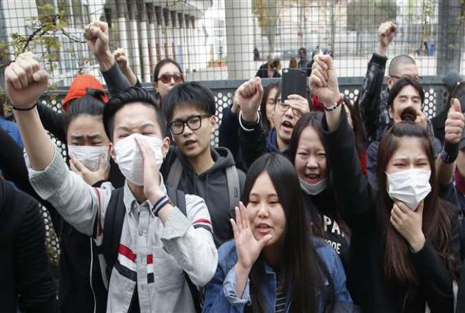 Demonstrators from the Asian community protest outside Paris