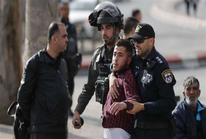 Israeli forces arrest a Palestinian man in Jerusalem al-Quds