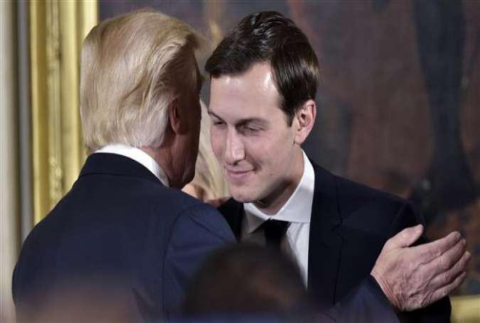 US President Donald Trump (L) congratulates his son-in-law and senior advisor Jared Kushner after the swearing-in of senior staff in the East Room of the White House on January 22, 2017 in Washington, DC. (Photo by AFP)