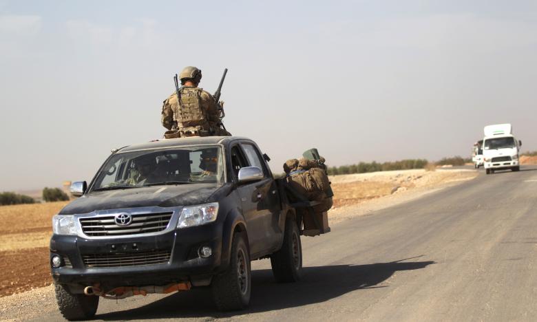 U.S. soldiers drive a military vehicle on the road connecting al-Rai town to Azaz city, in Syria's northern Aleppo countryside, October 4, 2016.