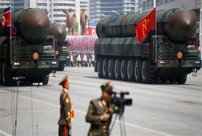Intercontinental ballistic missiles are driven past the stand with North Korean leader Kim Jong-un and other high-ranking officials during a military parade marking the 105th birth anniversary of the country