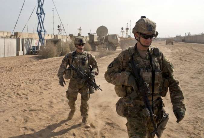In this Nov. 9, 2016 file photo, U.S. Army soldiers move through Qayara West Coalition base in Qayara, some 50 kilometers south of Mosul, Iraq.