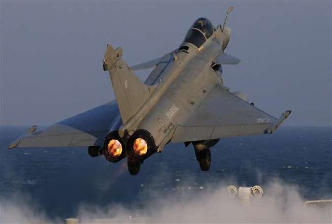 A Rafale fighter jet is catapulted on France’s flagship Charles de Gaulle aircraft carrier in the Persian Gulf on January 13, 2016, to conduct airstrikes as part of the alleged anti-Daesh US-led coalition. (Photo by AP)