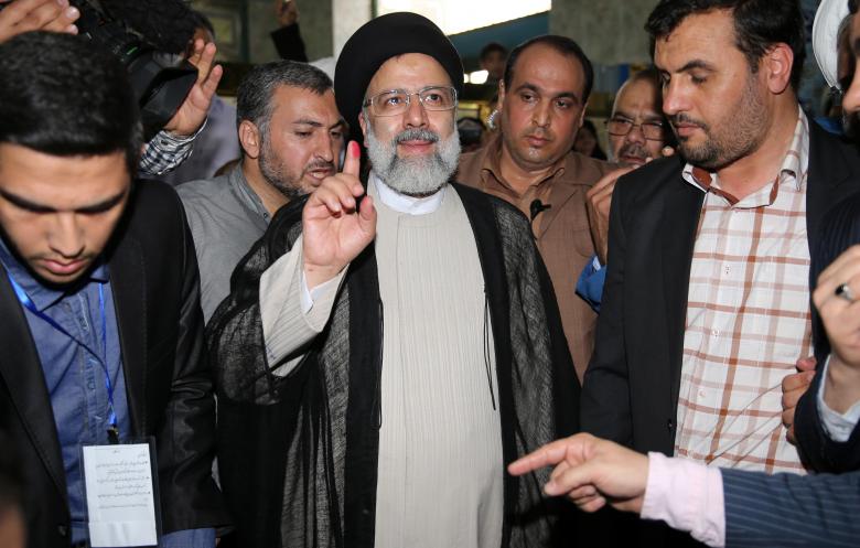 Iranian presidential candidate Ebrahim Raisi shows his ink-stained finger after casting his ballot during the presidential election in Tehran, Iran, May 19, 2017.