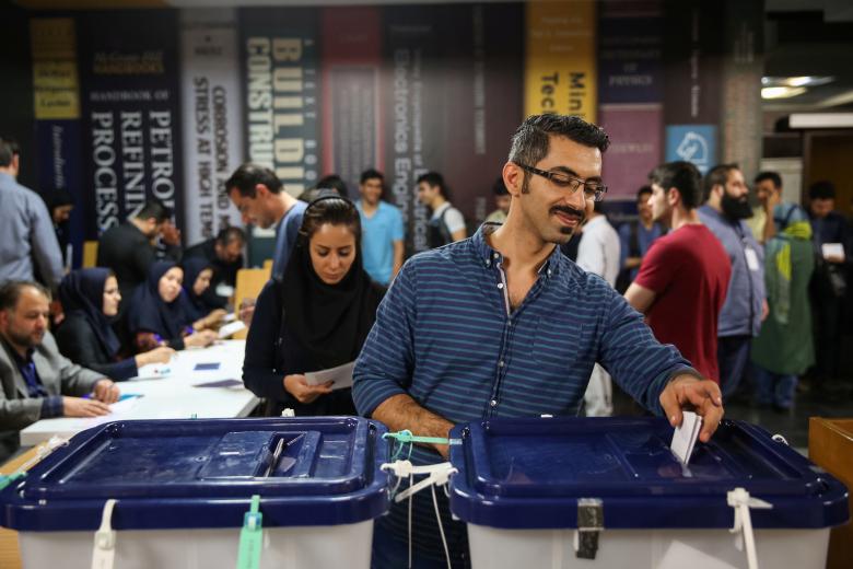 Iranians cast their votes during the presidential election in a polling station in Tehran, Iran, May 19, 2017.