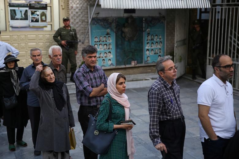 Iranian people stand in a queue to vote during the presidential election in Tehran, Iran, May 19, 2017.