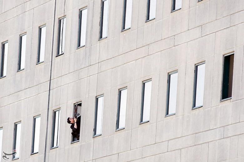 A member of Iranian forces aims his weapon during an attack on the Iranian parliament in central Tehran, Iran.