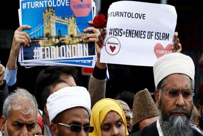 People hold placards during a gathering of representatives of the Muslim communities, south of London Bridge in London, June 7, 2017. (Photo by AFP)