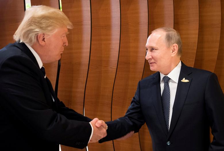 U.S. President Donald Trump and Russia's President Vladimir Putin shake hands during the G20 Summit in Hamburg, Germany in this still image taken from video.