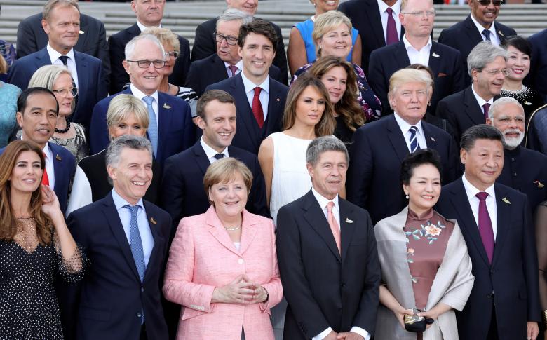 Participants of the G20 summit and their spouses pose for a family photo aroung German Chancellor Angela Merkel (2ndL) and her husband Joachim Sauer (3rdR) at the Elbphilharmonie before attending a concert in Hamburg.