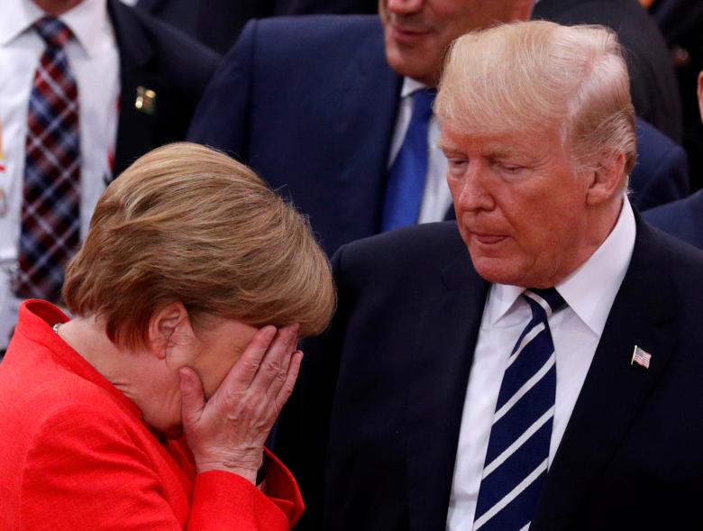 German Chancellor Angela Merkel reacts next to U.S. President Donald Trump.