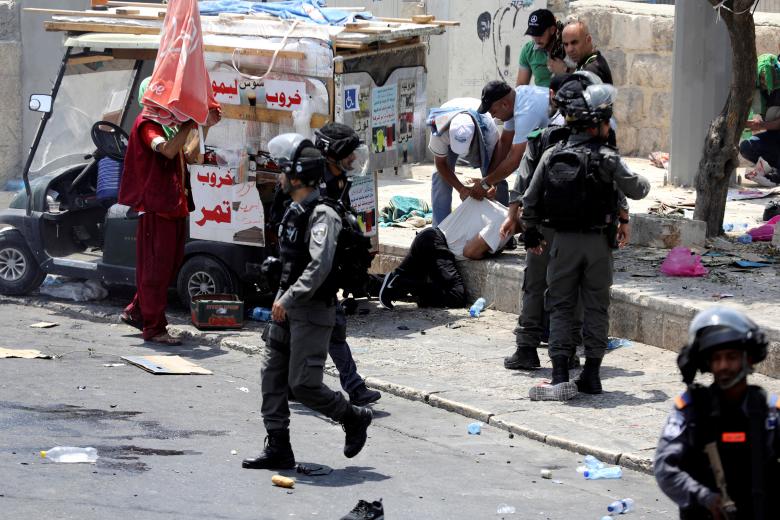Palestinians clash with Israeli forces after Friday prayer on a street outside Jerusalem