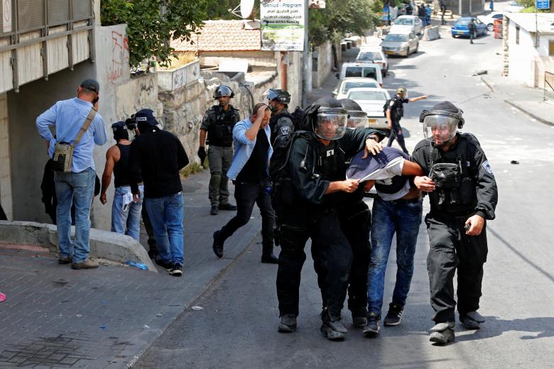 Israeli security forces arrest a Palestinian man following clashes outside Jerusalem