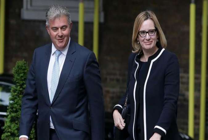 An AFP file photo of UK Immigration Minister Brandon Lewis (L) and Home Secretary Amber Rudd.