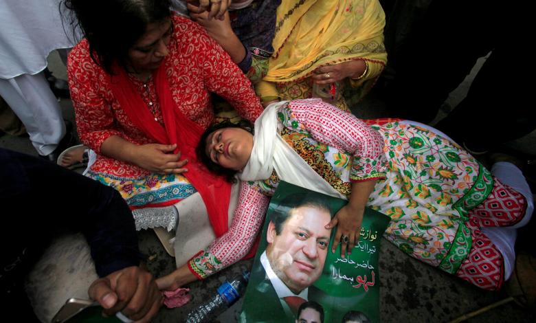 A supporter of Pakistan's Prime Minister Nawaz Sharif passes out after the Supreme Court's decision to disqualify Sharif in Lahore, Pakistan.