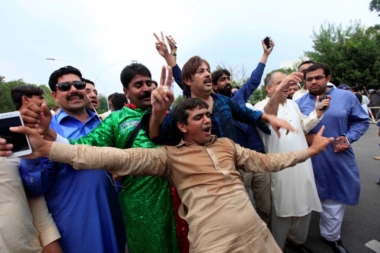 Opponents of Pakistan's Prime Minister Nawaz Sharif react after the Supreme Court's decision to disqualify Sharif, in Islamabad.