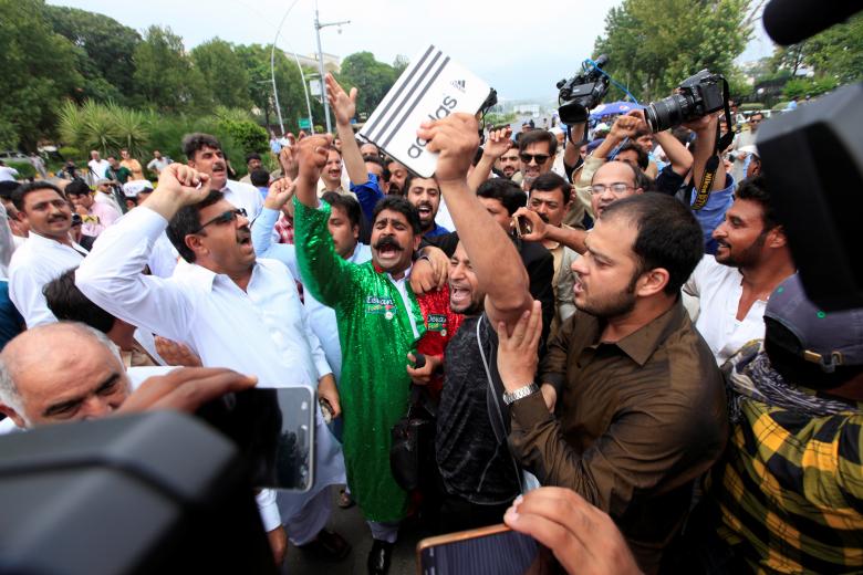 Opponents of Pakistan's Prime Minister Nawaz Sharif shout slogans after the Supreme Court's decision to disqualify Sharif, in Islamabad.